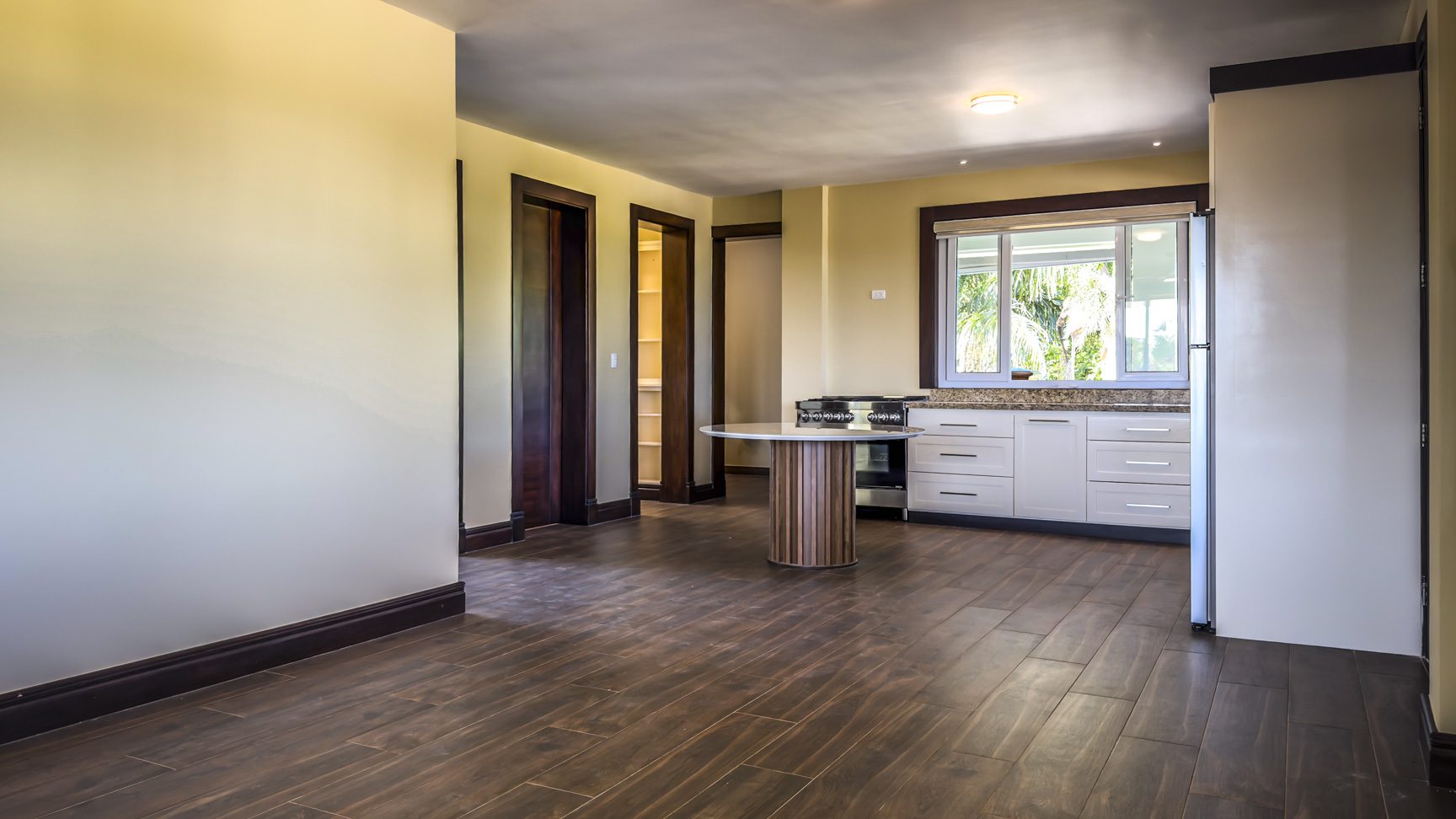 buyDRproperty Interior view of a 3 bedroom villa in La Mulata, showcasing kitchen and dining area with wood floors. Sosua Real Estate