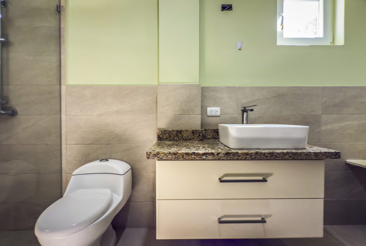 buyDRproperty Bathroom with toilet, vanity, and shower in La Mulata villa. Sosua Real Estate