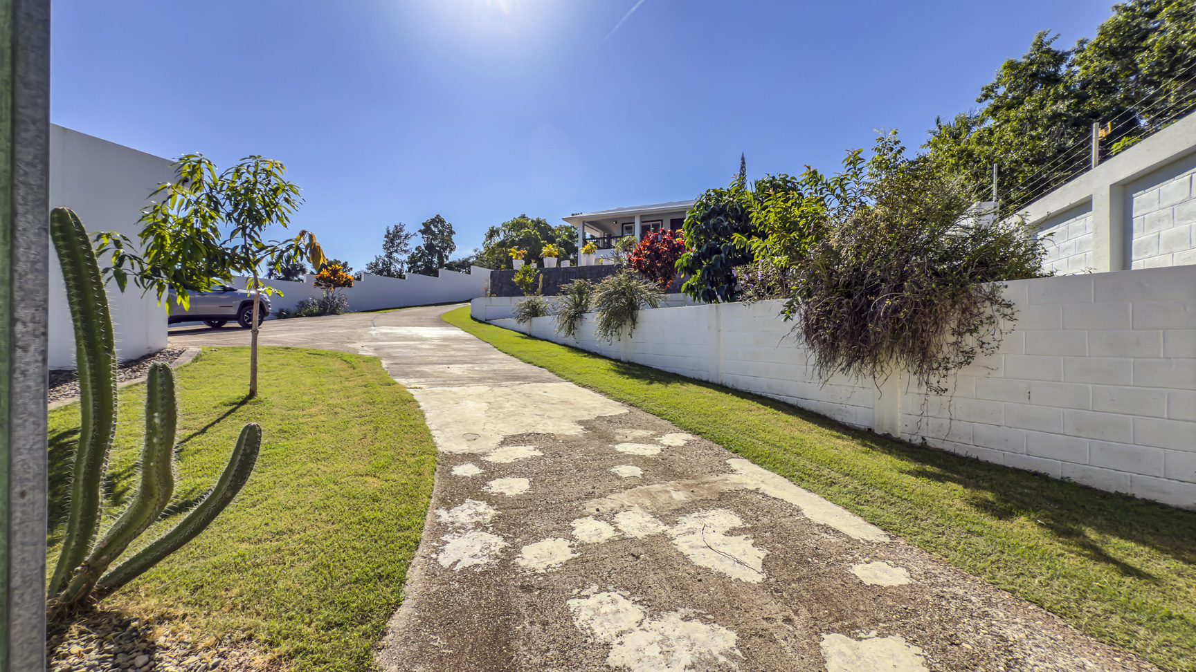 buyDRproperty Driveway leading to a 3 bedroom villa in La Mulata, Dominican Republic, showcasing the property's entrance. Sosua Real Estate