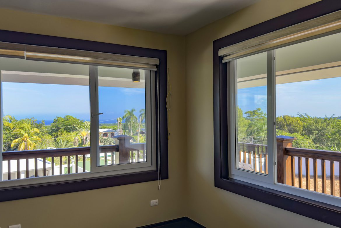 buyDRproperty Bright room with two windows showcasing the view from this 3 bedroom villa for sale in La Mulata. Sosua Real Estate