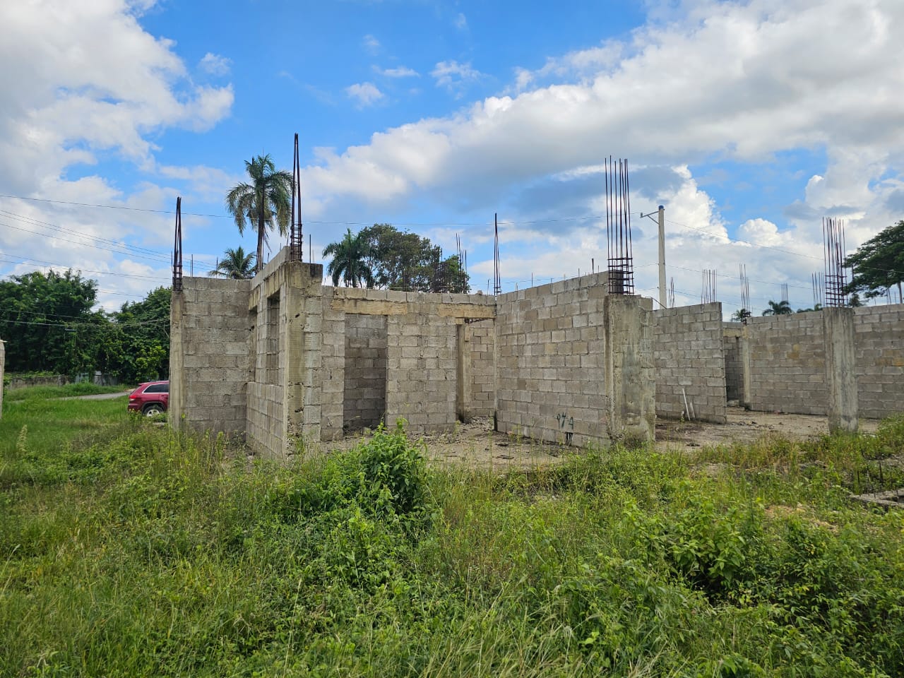 buyDRproperty Construction started on a lot near Sosúa, showing cinder block walls and rebar for future development. Sosua Real Estate
