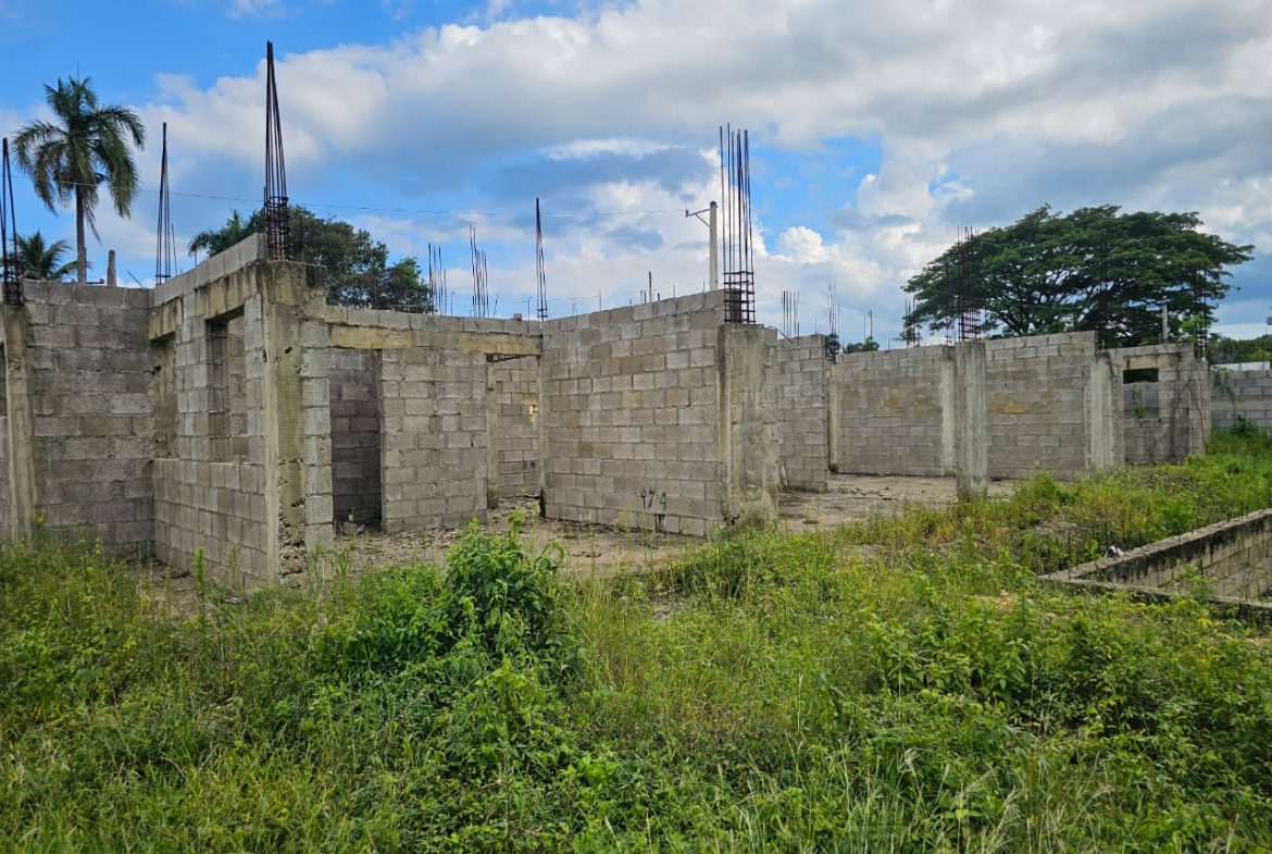 buyDRproperty Construction started on a lot near Sosúa, showing concrete block walls and rebar for a potential casa linda development. Sosua Real Estate