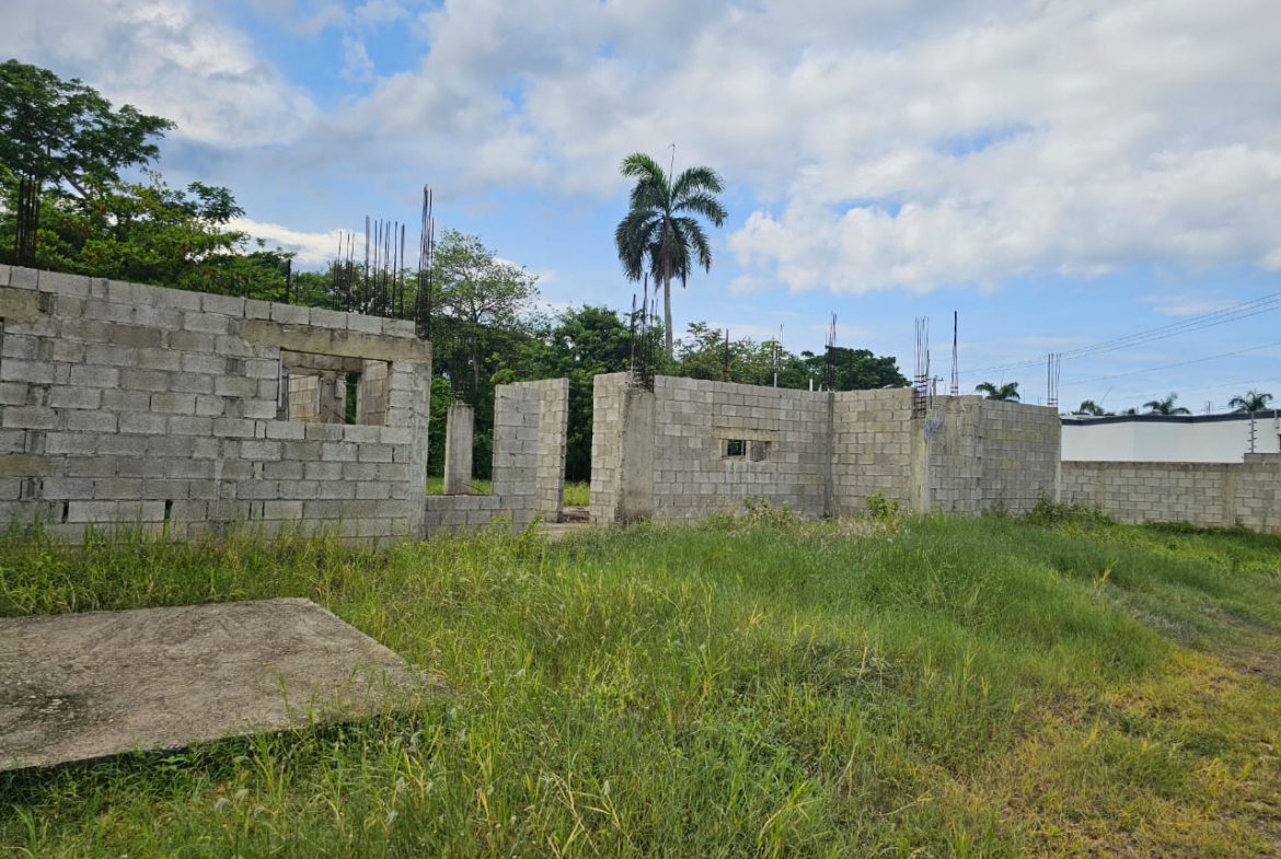 buyDRproperty Construction started on a casa linda development lot, showing concrete block walls and rebar. Sosua Real Estate