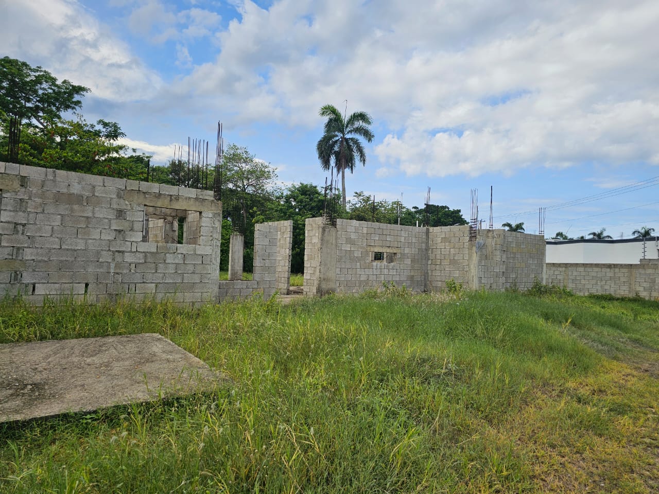 buyDRproperty Construction started on a casa linda development lot, showing concrete block walls and rebar. Sosua Real Estate