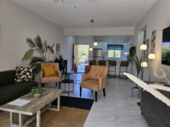 buyDRproperty Open-concept living room with modern furniture and bright, natural light. Sosua Real Estate
