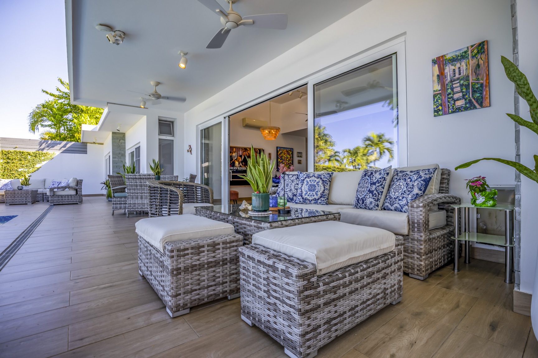 buyDRproperty Outdoor patio with wicker furniture, cushions, and sliding glass doors. Sosua Real Estate