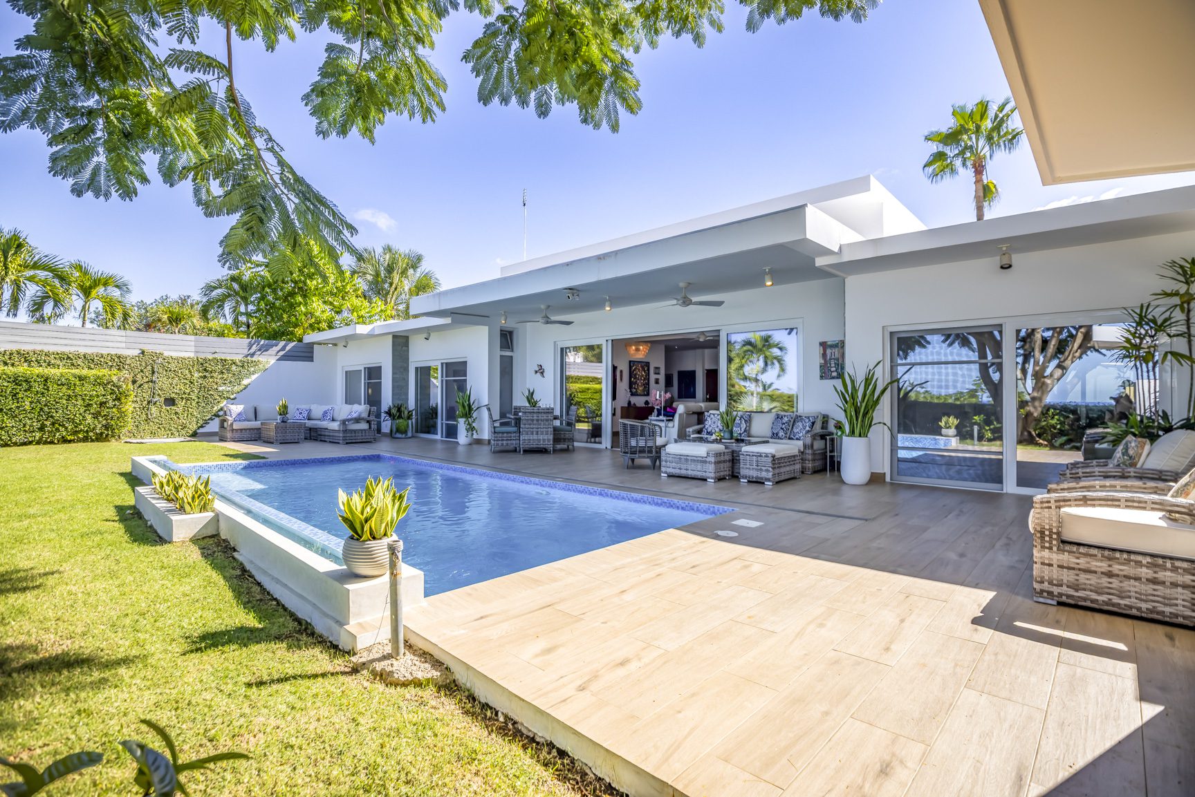 buyDRproperty Luxury villa with pool, patio, and lush green lawn. Sosua Real Estate