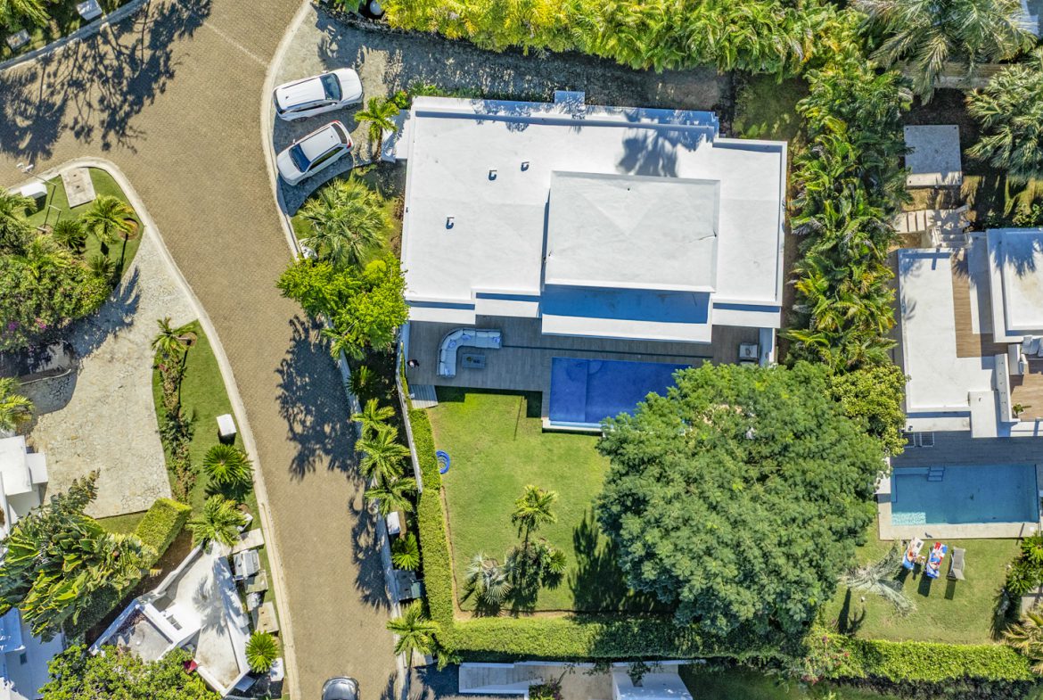 buyDRproperty Aerial view of a luxury villa with pool and lush landscaping. Sosua Real Estate