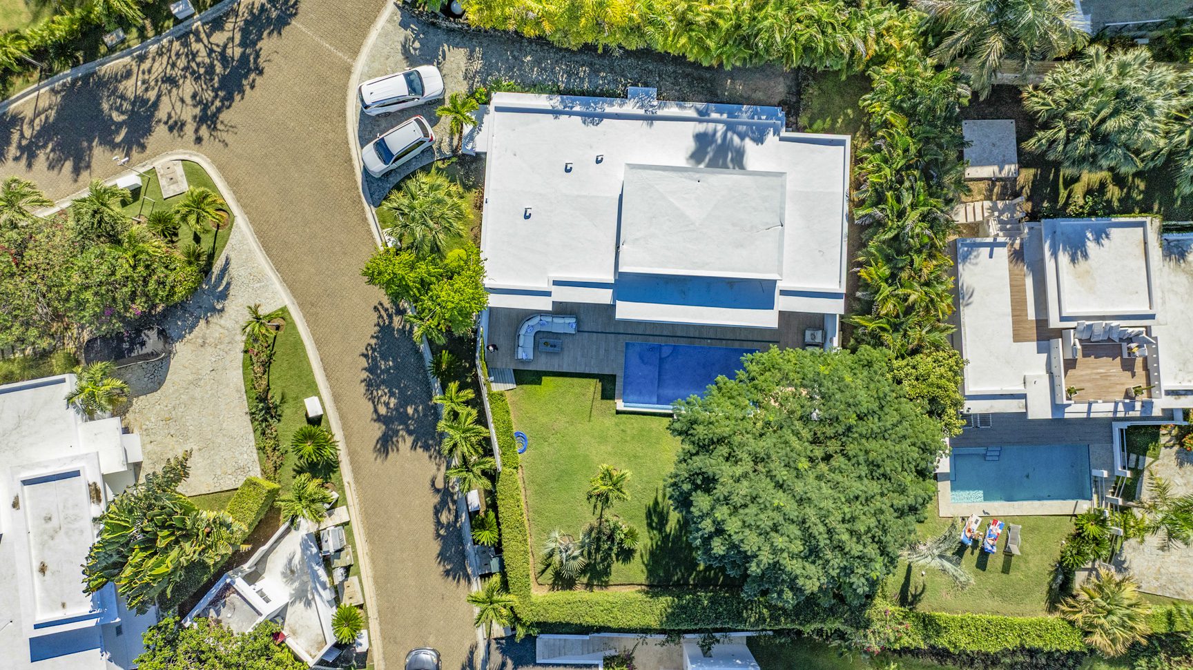 buyDRproperty Aerial view of a luxury villa with pool and lush landscaping. Sosua Real Estate