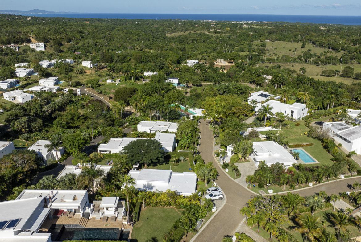 buyDRproperty Aerial view of luxury villas with pools in a tropical setting. Sosua Real Estate