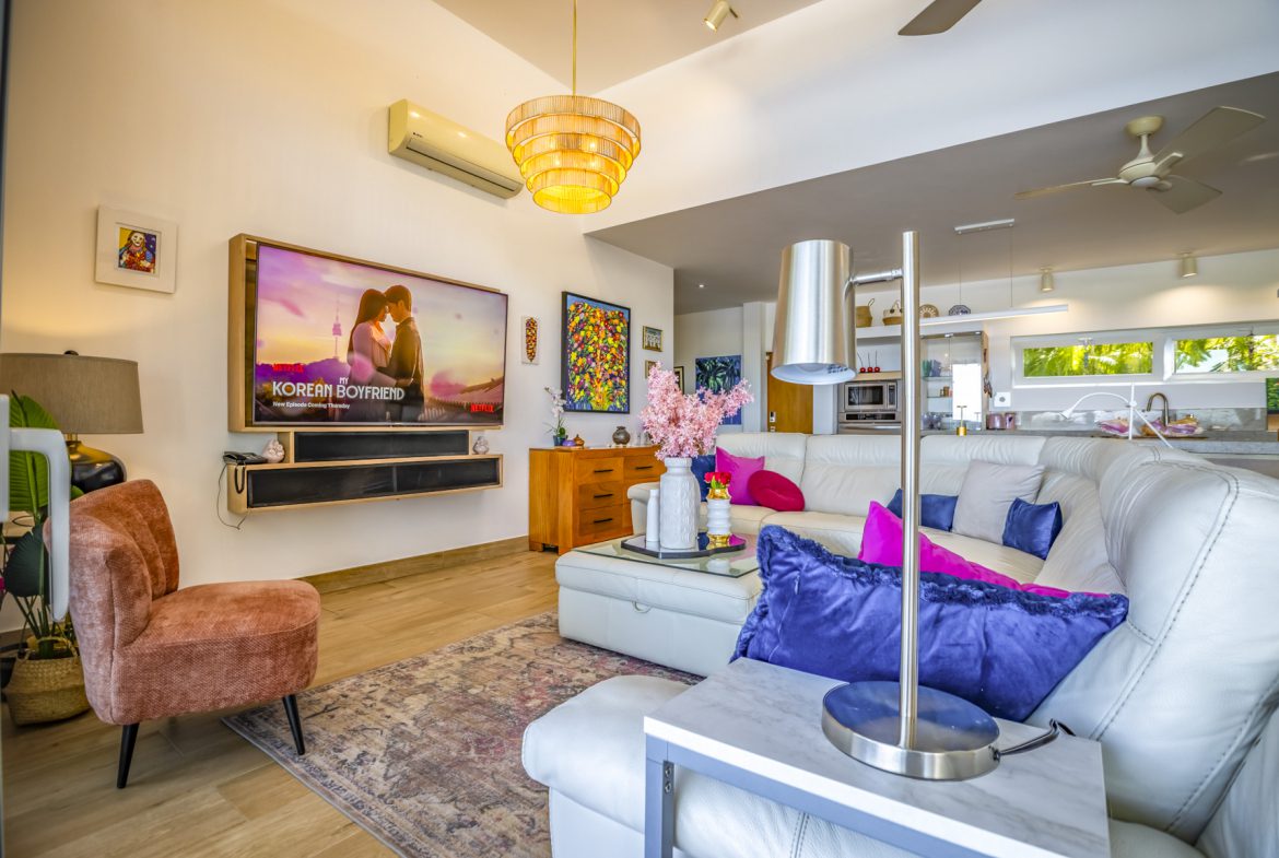 buyDRproperty Stylish living room with TV, modern decor, and comfortable seating. Sosua Real Estate