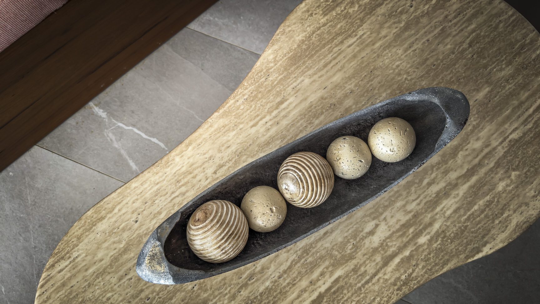buyDRproperty Decorative balls in a rustic bowl on a marble coffee table. Sosua Real Estate