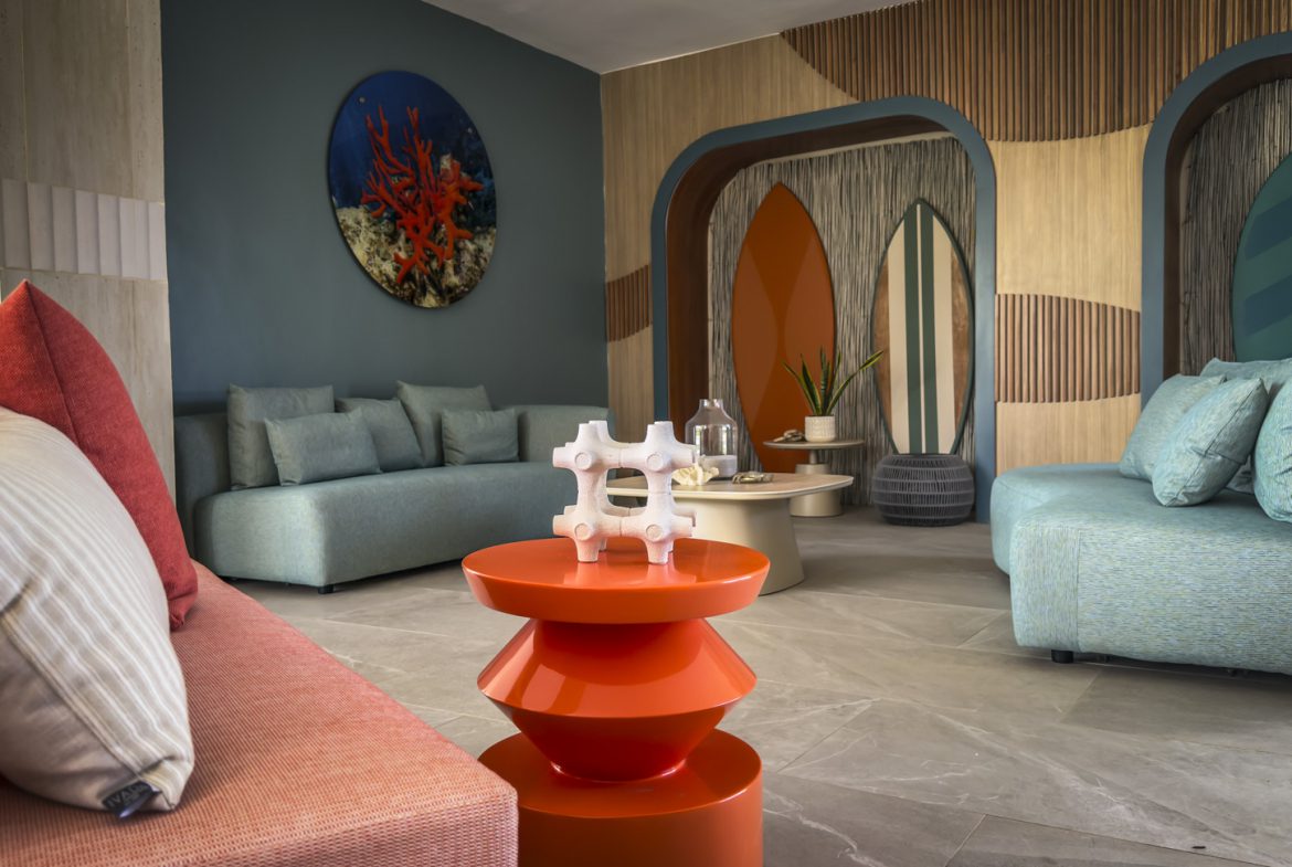 buyDRproperty Stylish hotel lobby with surfboards and colorful decor. Sosua Real Estate