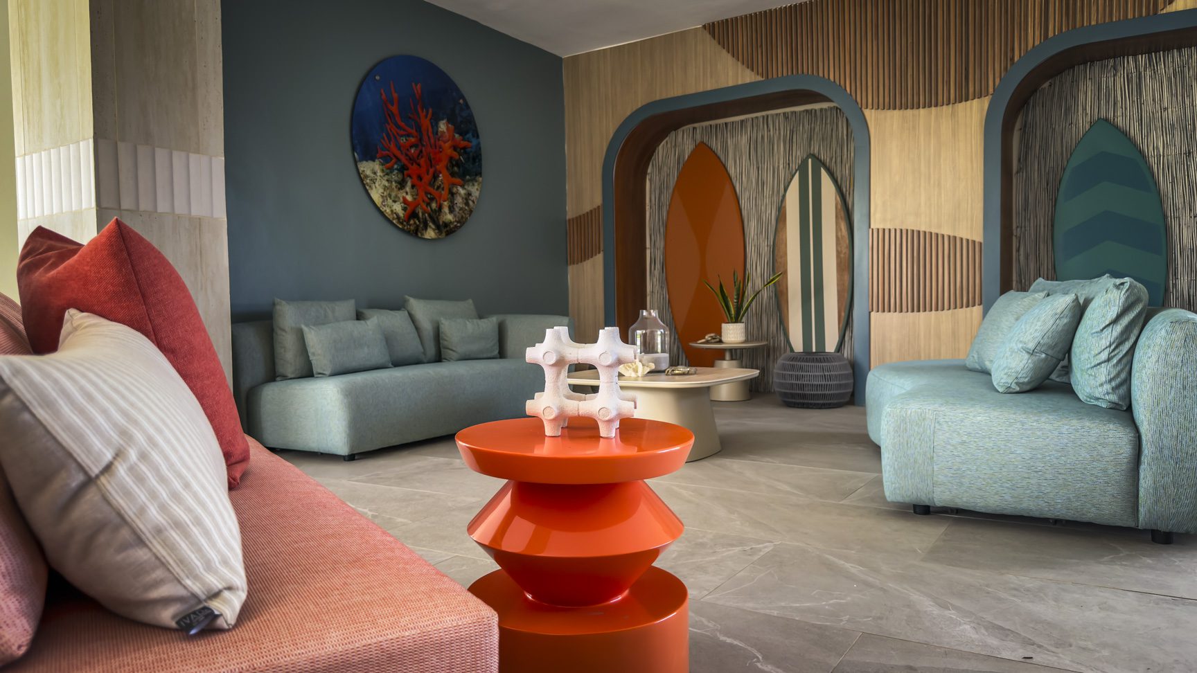 buyDRproperty Stylish hotel lobby with surfboards and colorful decor. Sosua Real Estate