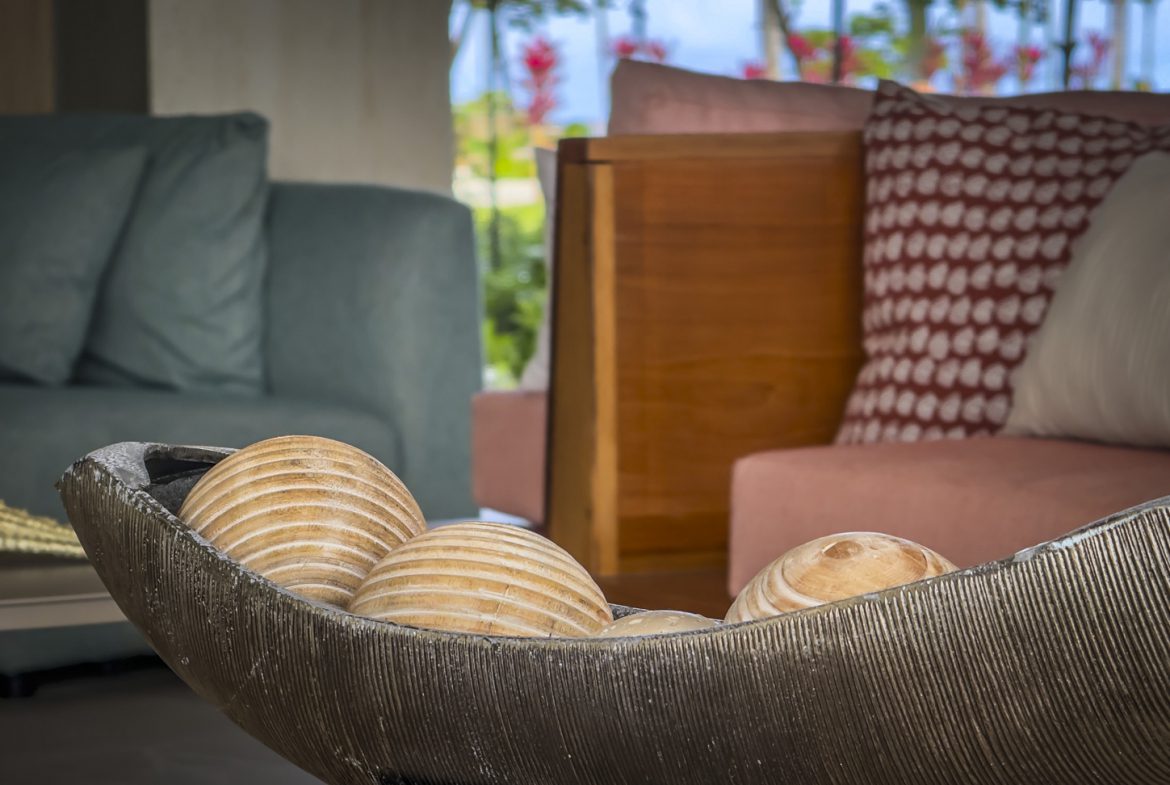 buyDRproperty Seashells in a decorative bowl on a coffee table in a coastal-style living room. Sosua Real Estate