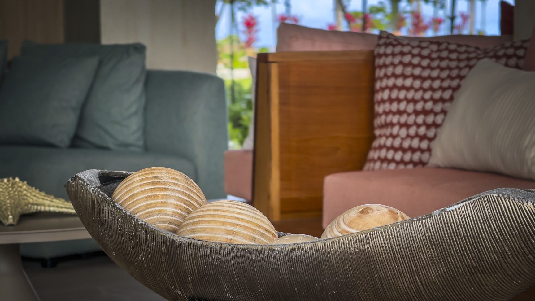 buyDRproperty Seashells in a decorative bowl on a coffee table in a coastal-style living room. Sosua Real Estate