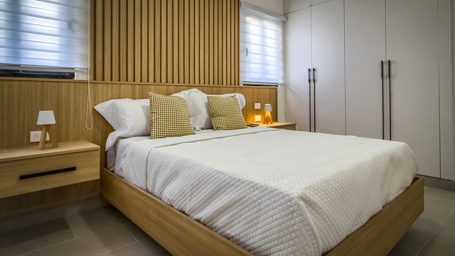 Modern bedroom in The Wave condo, Cabarete, with wooden accents.
