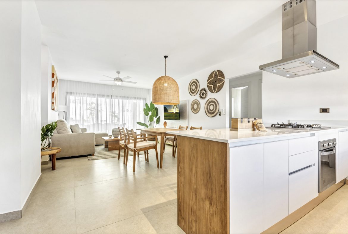 buyDRproperty Bright, open-concept living area with modern kitchen, dining table, and comfortable lounge in a well-lit space. Sosua Real Estate