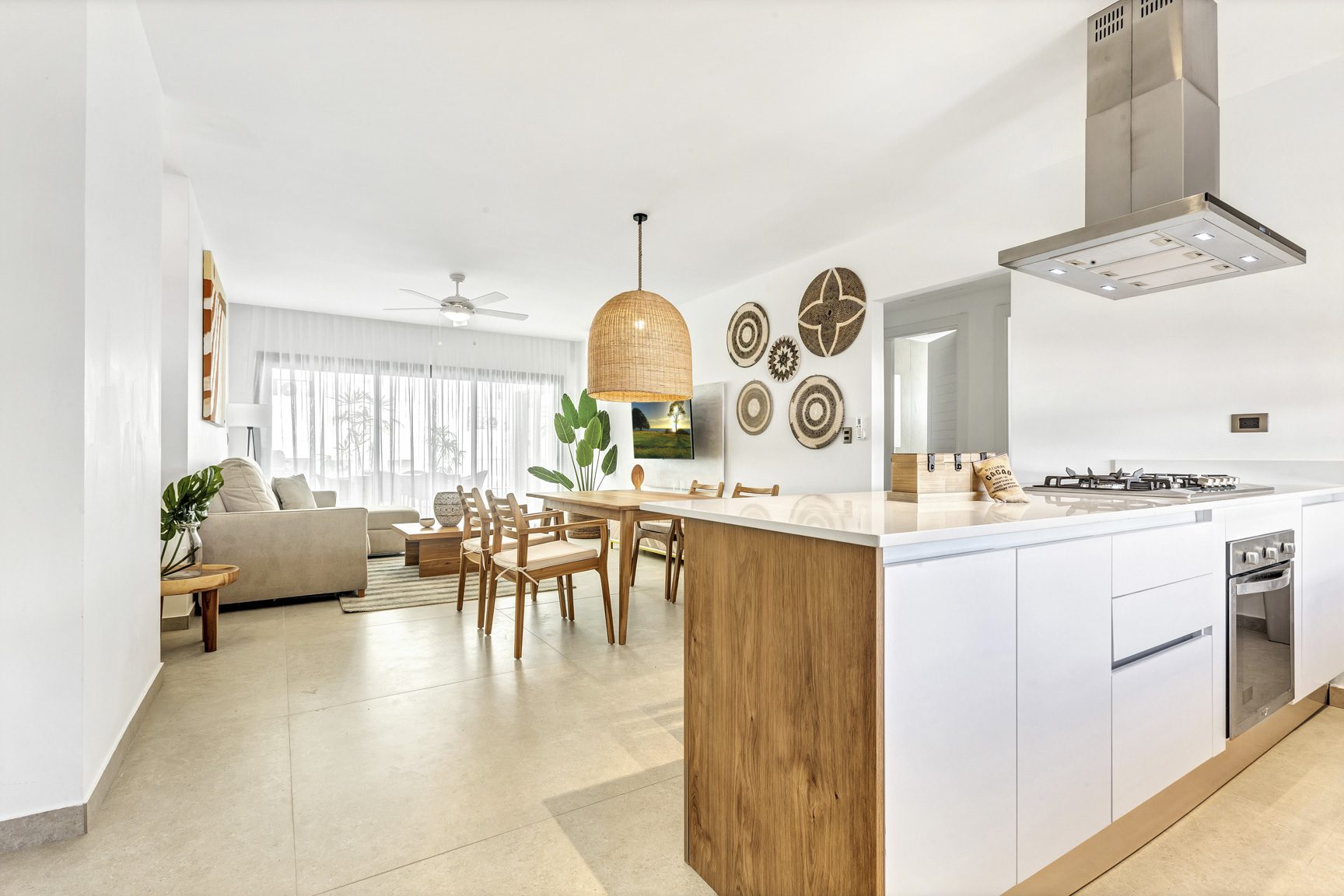 buyDRproperty Bright, open-concept living area with modern kitchen, dining table, and comfortable lounge in a well-lit space. Sosua Real Estate