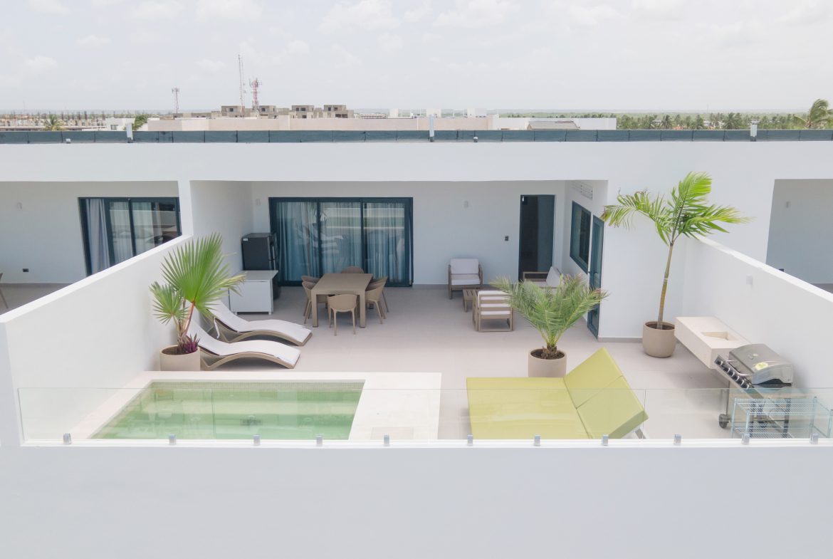 buyDRproperty Rooftop terrace with pool, lounge chairs, dining set, and grill. Sosua Real Estate