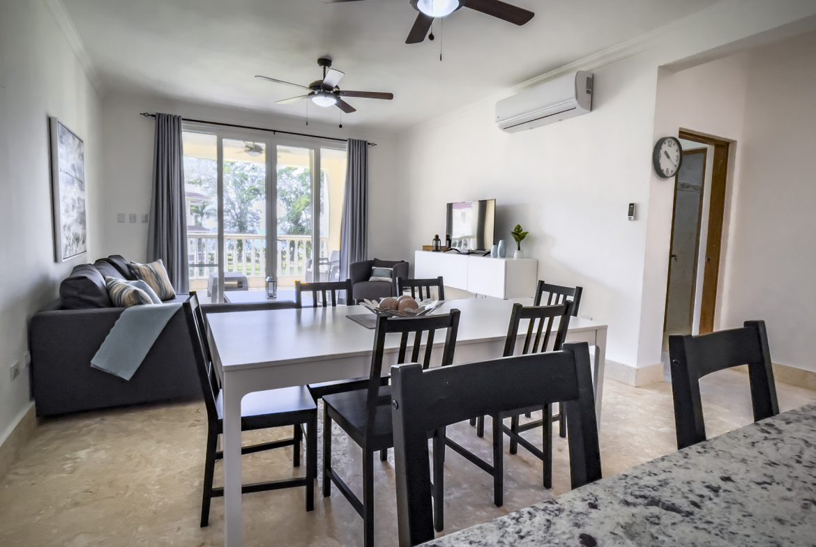 buyDRproperty Bright living room with modern furniture, ceiling fans, and a dining area Sosua Real Estate