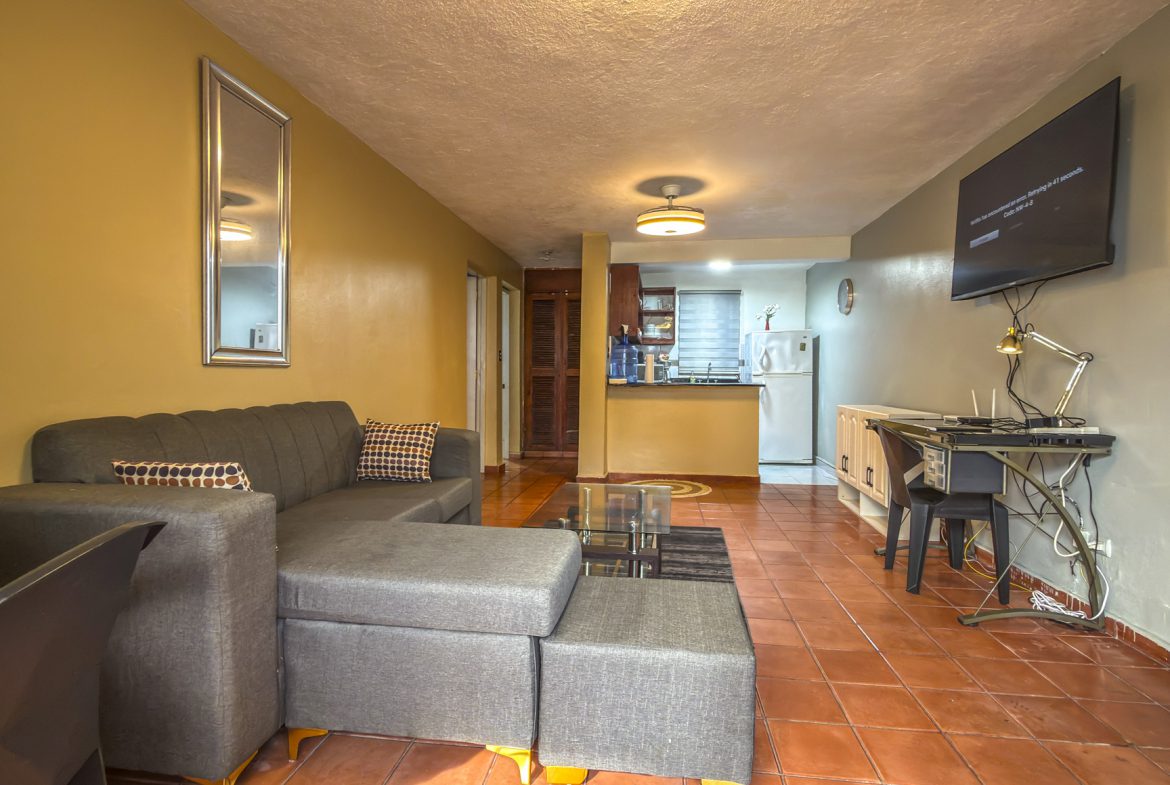 Living room and dining area of 1-bedroom condo for sale in central Sosúa