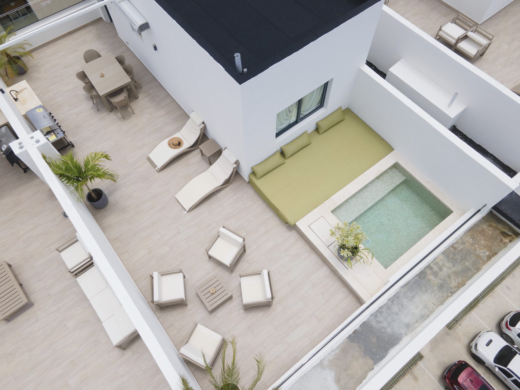 buyDRproperty Rooftop patio with pool, dining, lounge chairs, and modern design elements. Sosua Real Estate