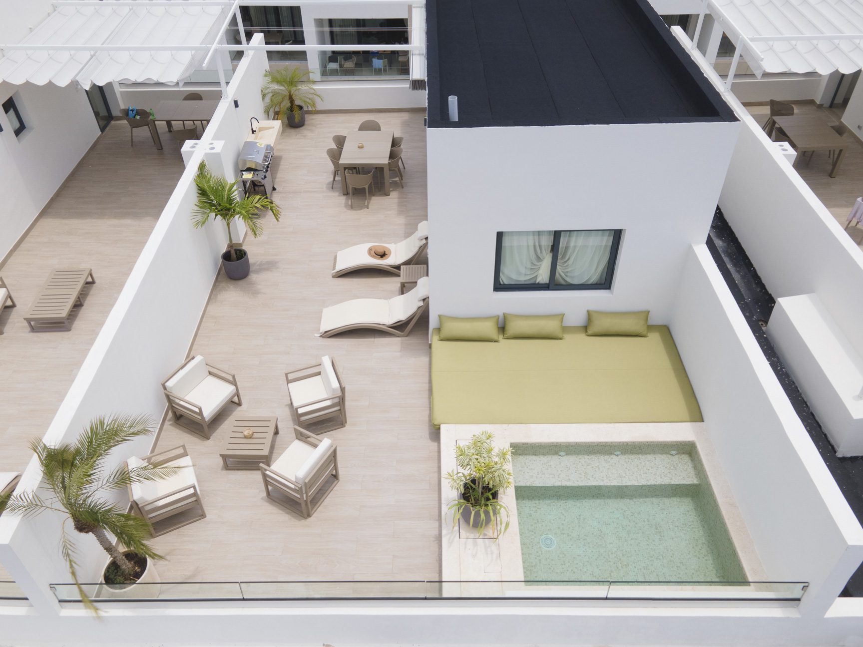 buyDRproperty Rooftop terrace with pool, lounge chairs, dining table, and modern outdoor furniture. Sosua Real Estate