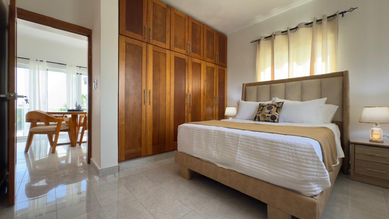 Furnished bedroom with built-in wardrobes at Breeze Condos in Playa Laguna, Sosúa