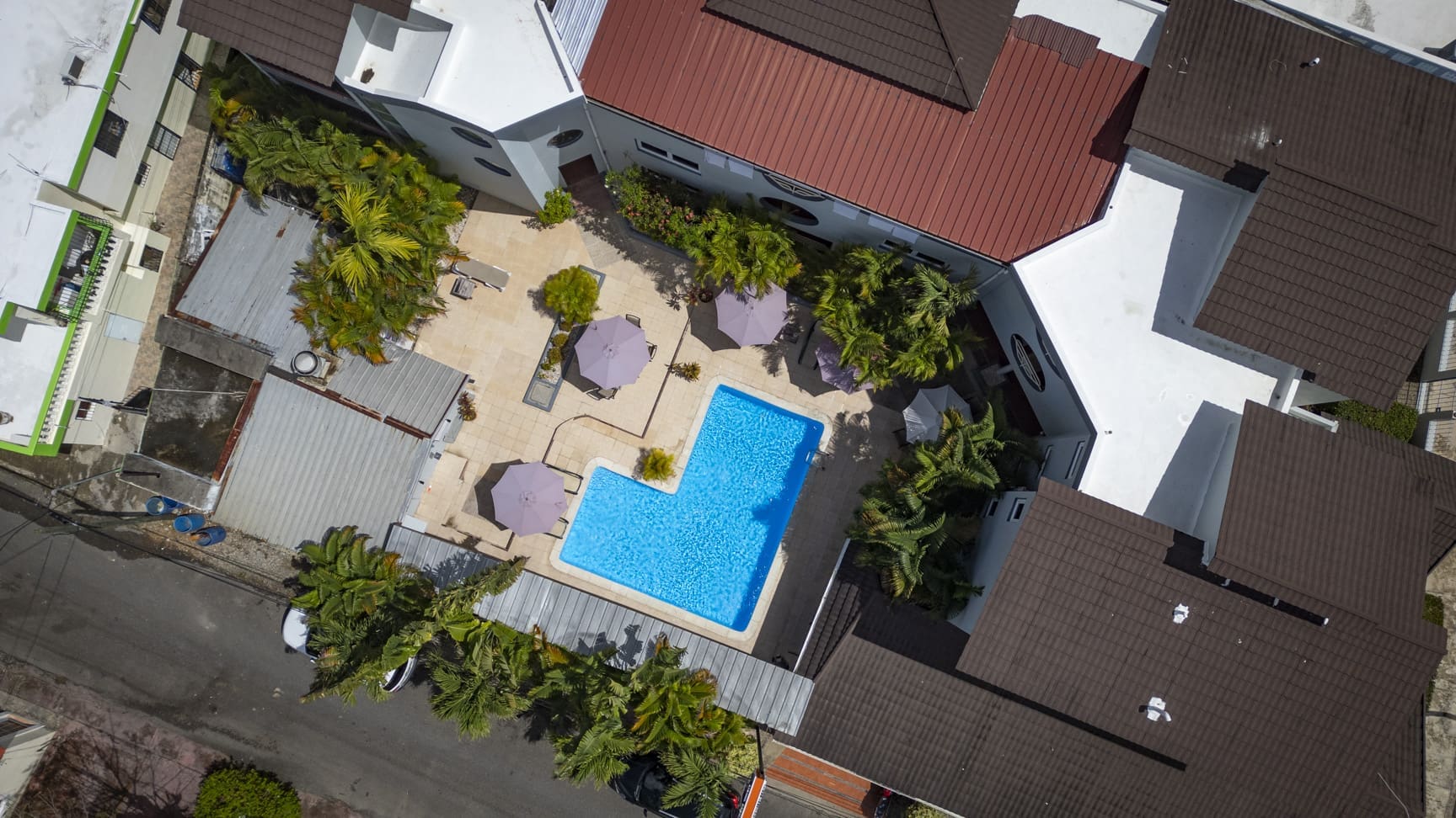 Aerial view of Don Andres hotel resort pool with lounge chairs and palm trees. Sosua Real Estate