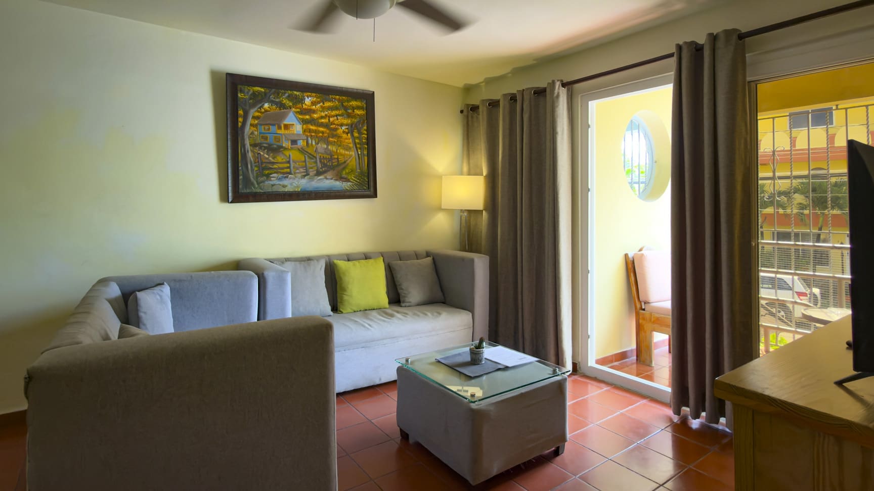 Cozy living room with sectional sofa, coffee table, and balcony door