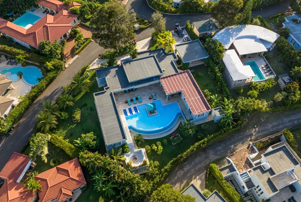 buyDRproperty Aerial view of luxurious villa with swimming pool and lush tropical landscaping Sosua Real Estate