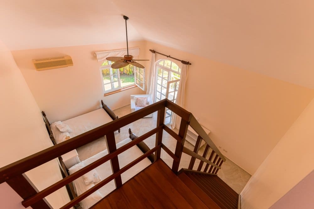 buyDRproperty View from above of a bedroom with two beds, a ceiling fan, and a window. Sosua Real Estate