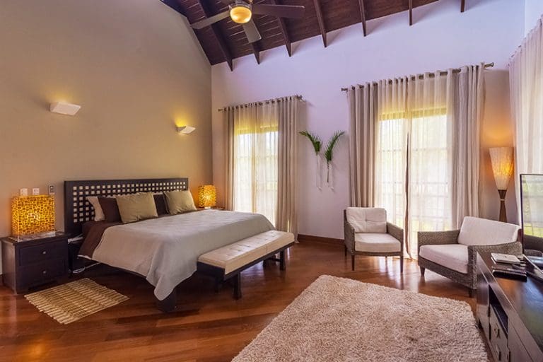buyDRproperty Spacious bedroom with vaulted ceiling, king bed, and natural light Sosua Real Estate