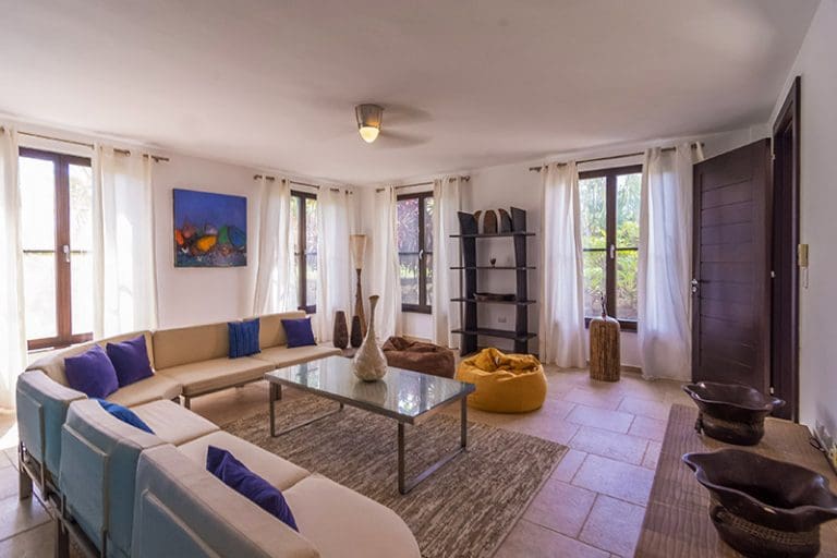 buyDRproperty Spacious living room with large sectional sofa, bean bags, and artwork Sosua Real Estate