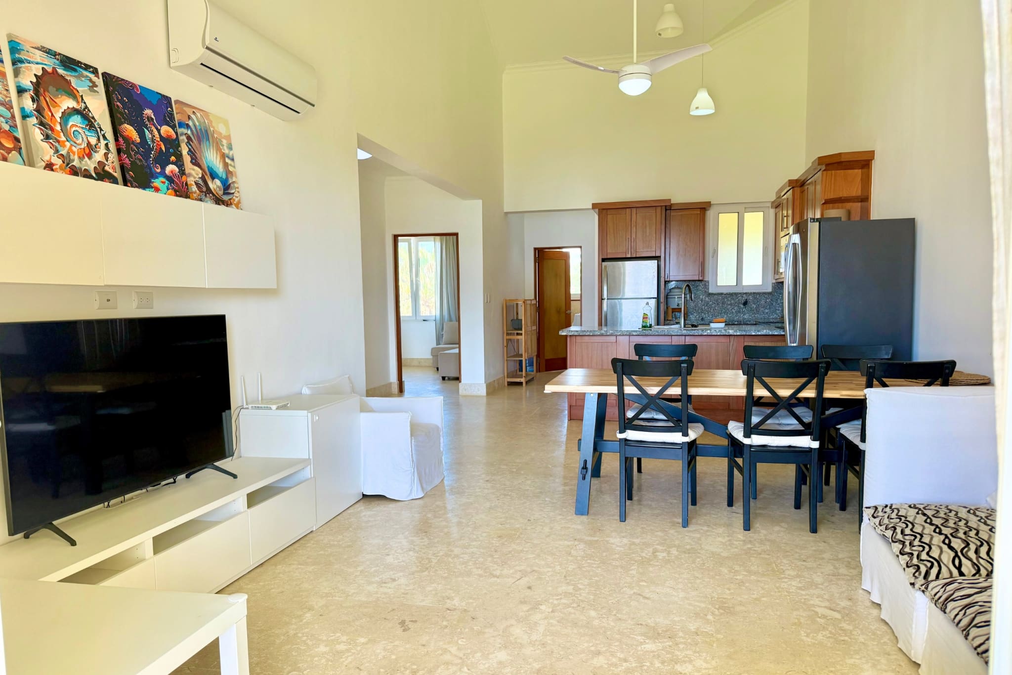 Spacious open-plan living, dining, and kitchen area with modern furniture.