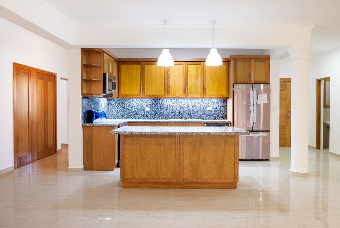Modern kitchen with granite island in Hispaniola Beach 3-bedroom condo in Sosua