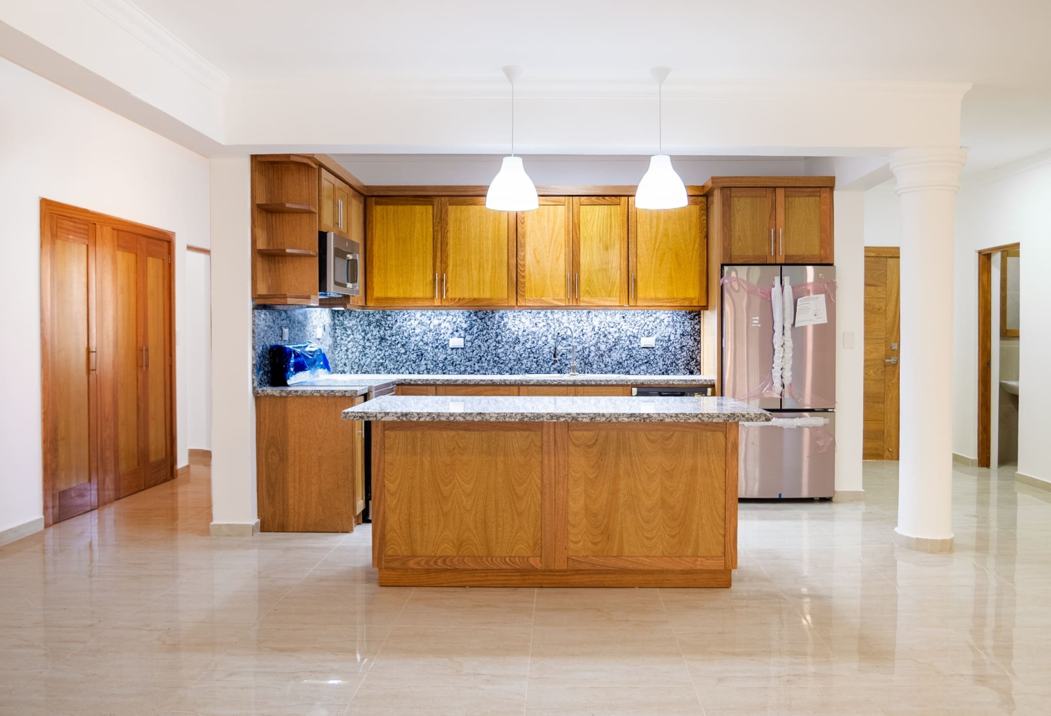 Modern kitchen with granite island in Hispaniola Beach 3-bedroom condo in Sosua