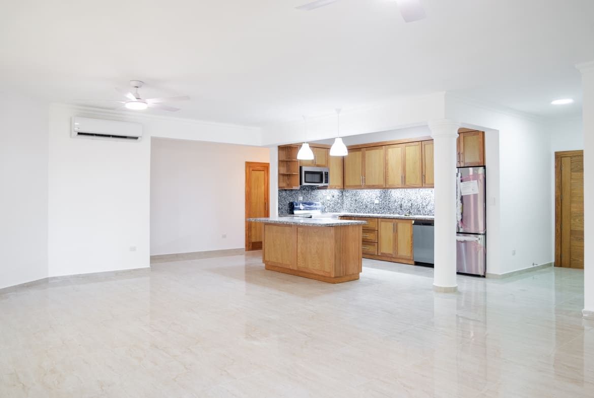 Open-plan living room and kitchen in 3-bedroom Hispaniola Beach condo in Sosua