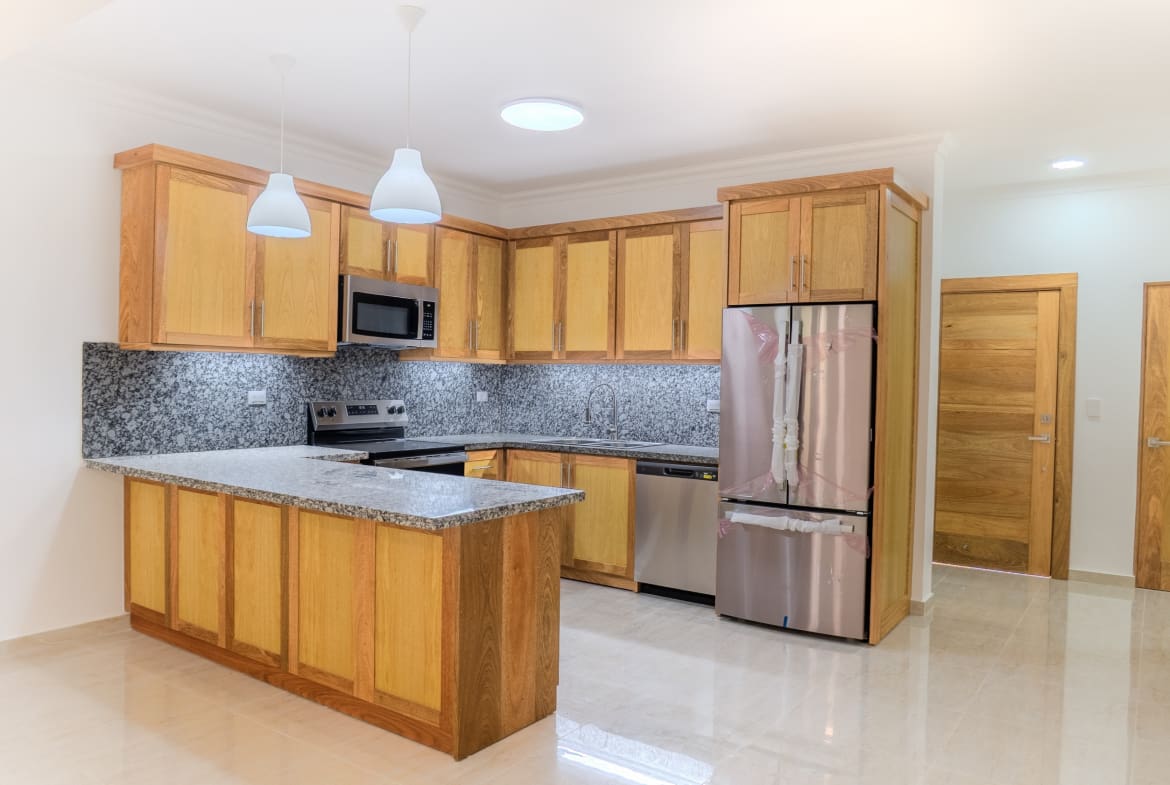 Modern kitchen with island in 2-bedroom Hispaniola Beach condo in Sosua