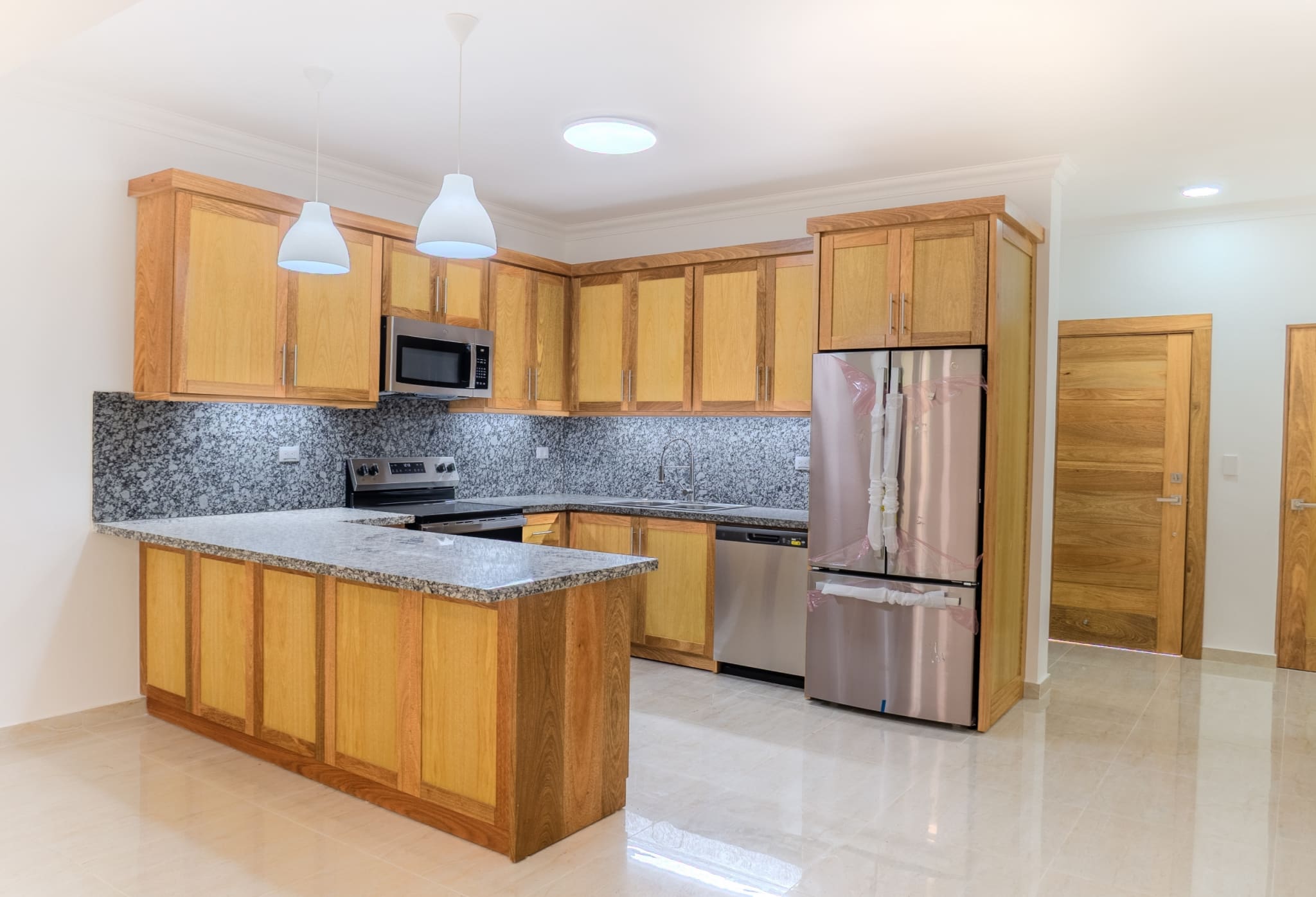 Modern kitchen with island in 2-bedroom Hispaniola Beach condo in Sosua