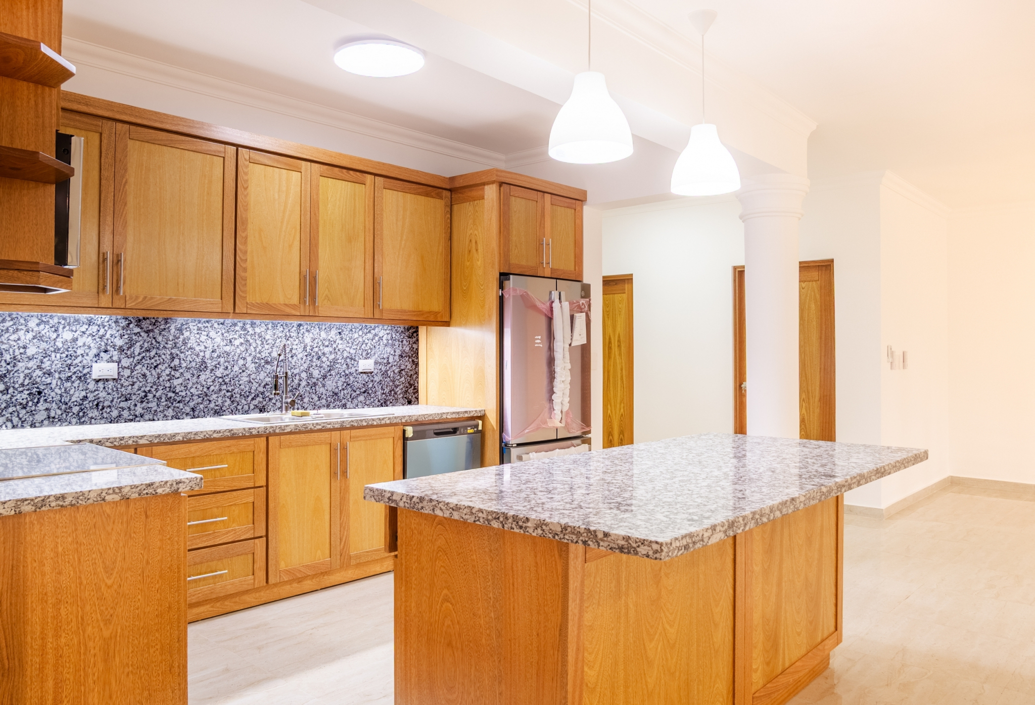 Modern wooden kitchen with granite island and countertops