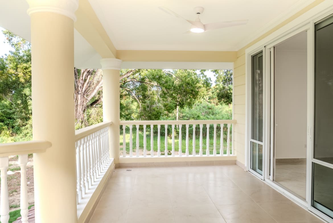 Covered terrace with sliding glass doors at Hispaniola Beach condo in Sosua