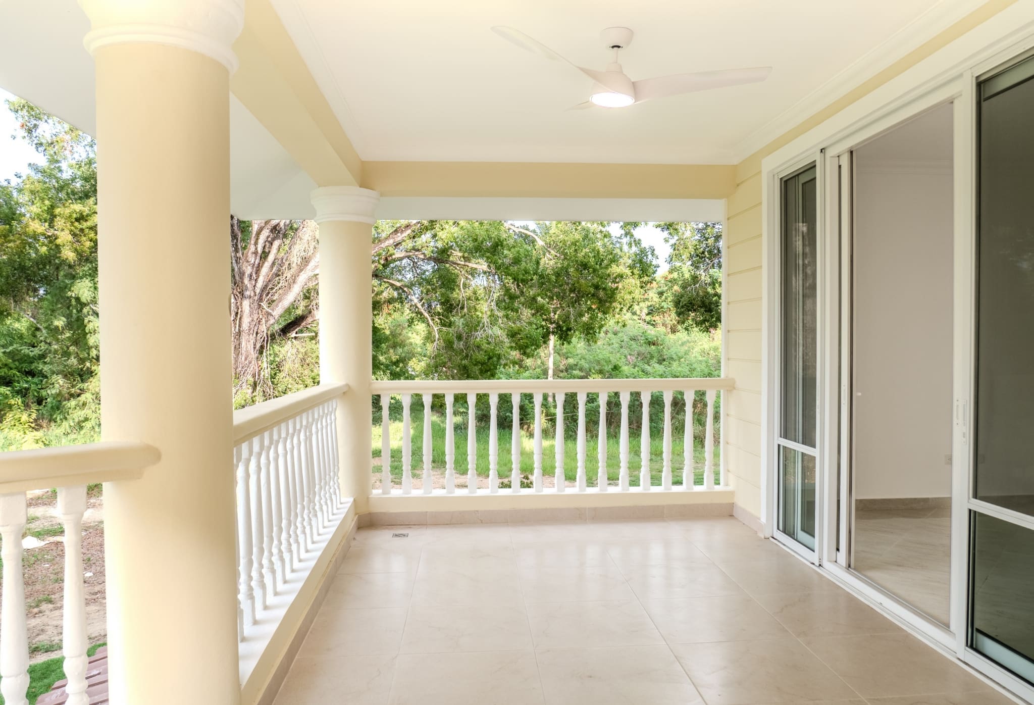 Covered terrace with sliding glass doors at Hispaniola Beach condo in Sosua