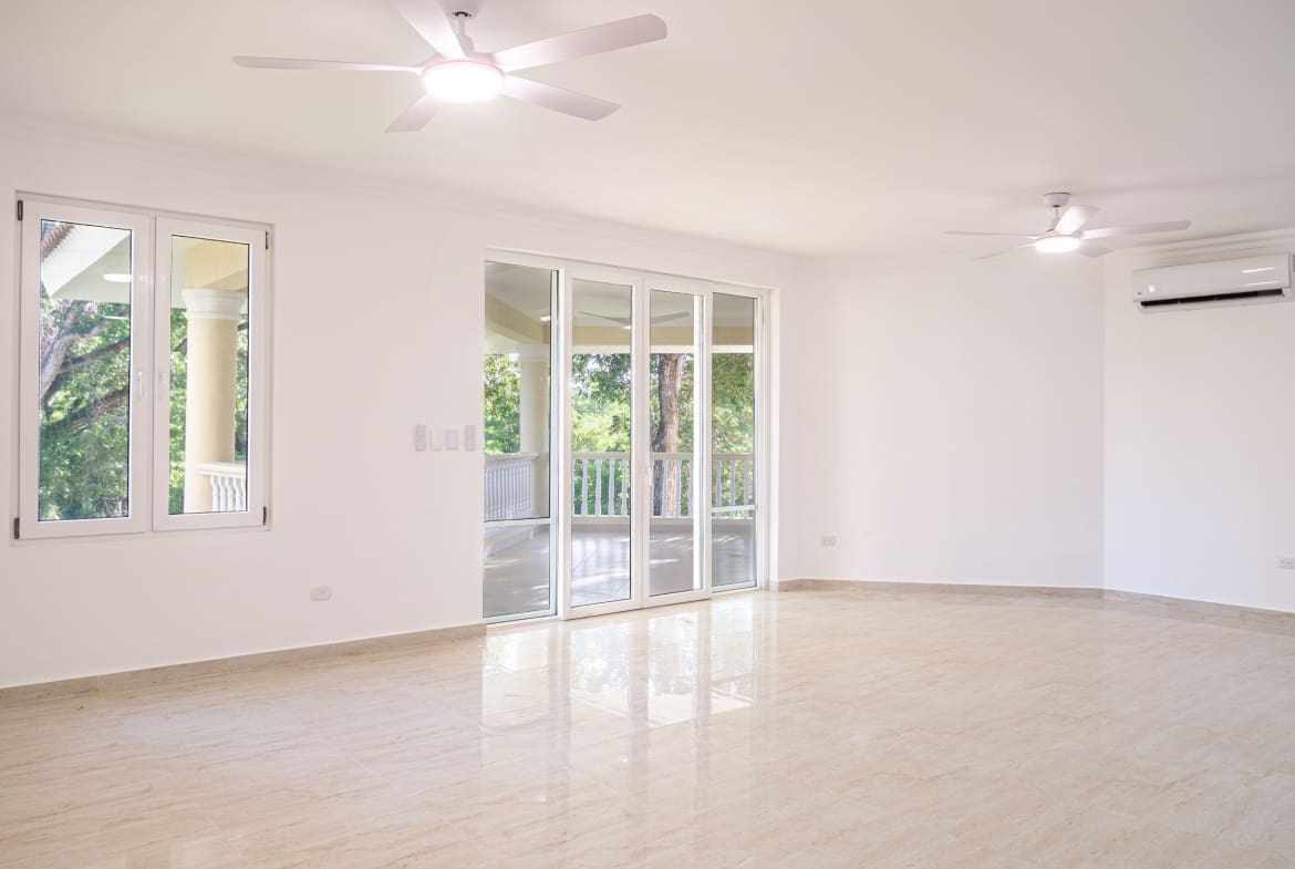 Spacious bright living room with balcony access in 3-bedroom Hispaniola Beach condo in Sosua