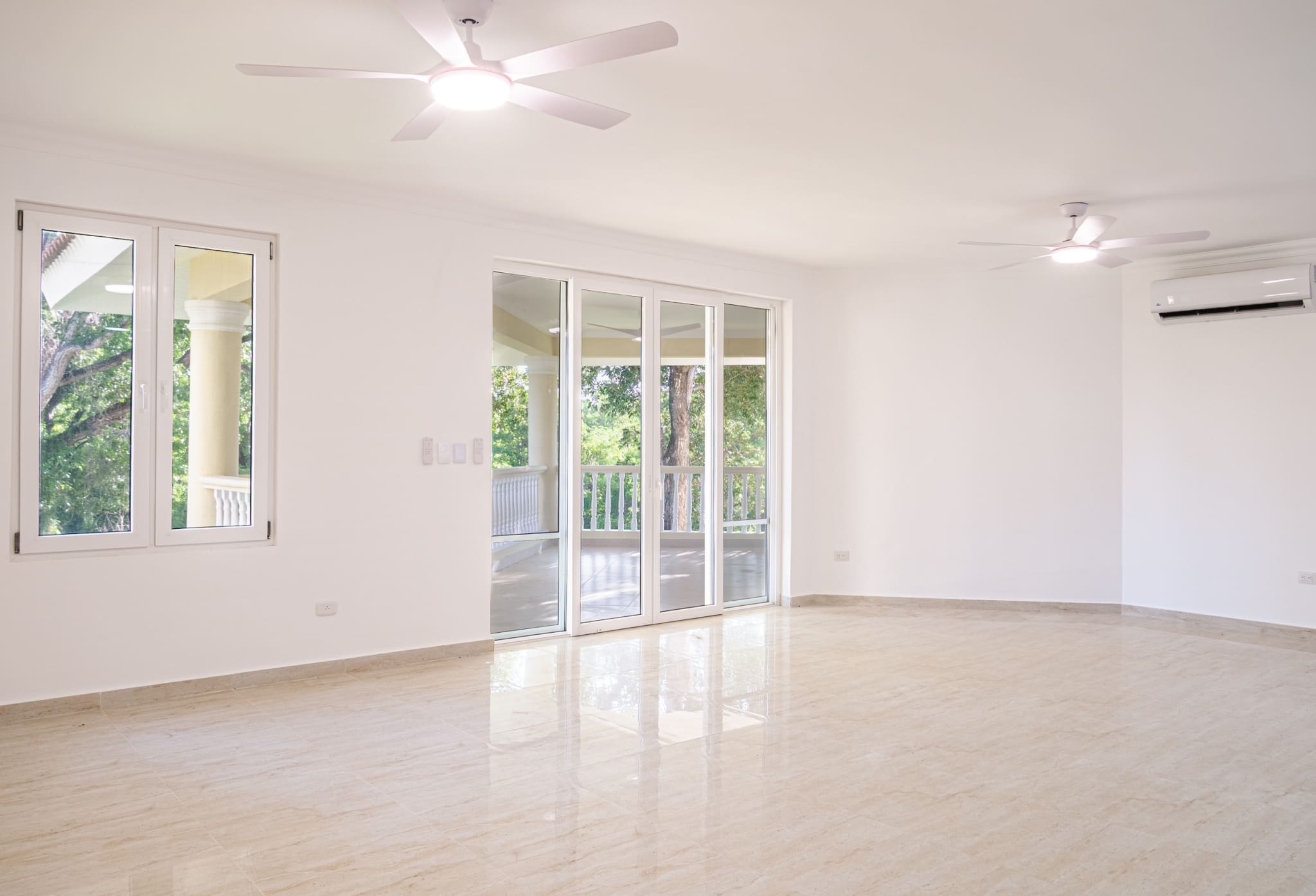 Spacious bright living room with balcony access in 3-bedroom Hispaniola Beach condo in Sosua