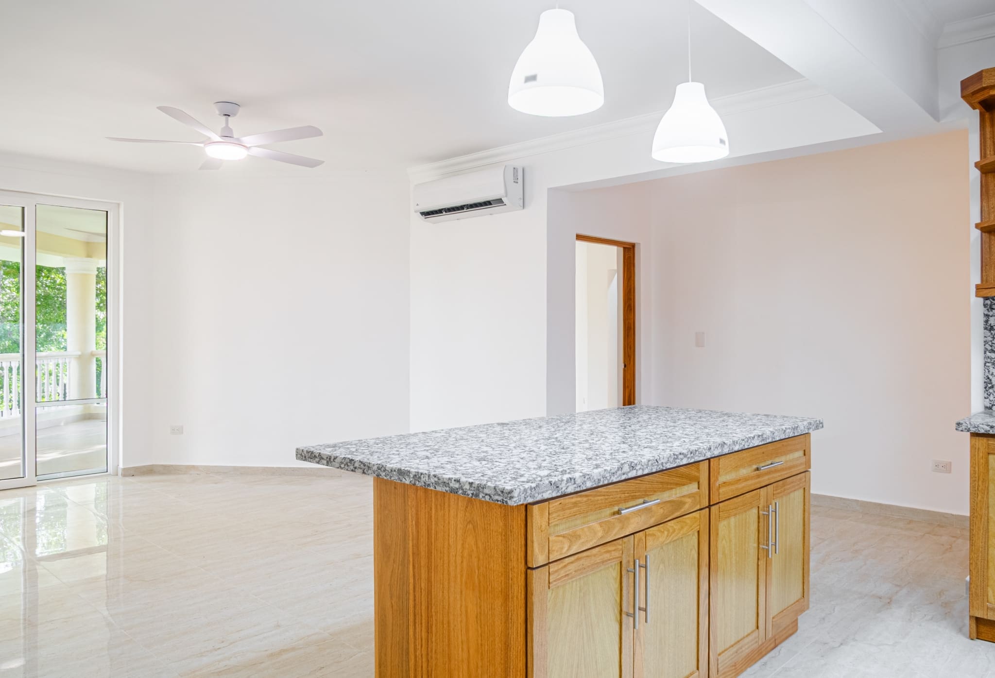 Granite kitchen island and open living area in 3-bedroom Hispaniola Beach condo in Sosua