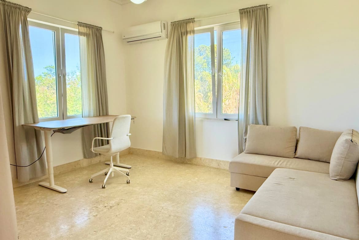 Bright room with desk, chair, and sofa, ideal for Sosua Cabarete real estate investment.