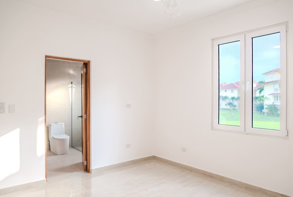 Bright bedroom with ensuite bathroom in Hispaniola Beach condo in Sosua