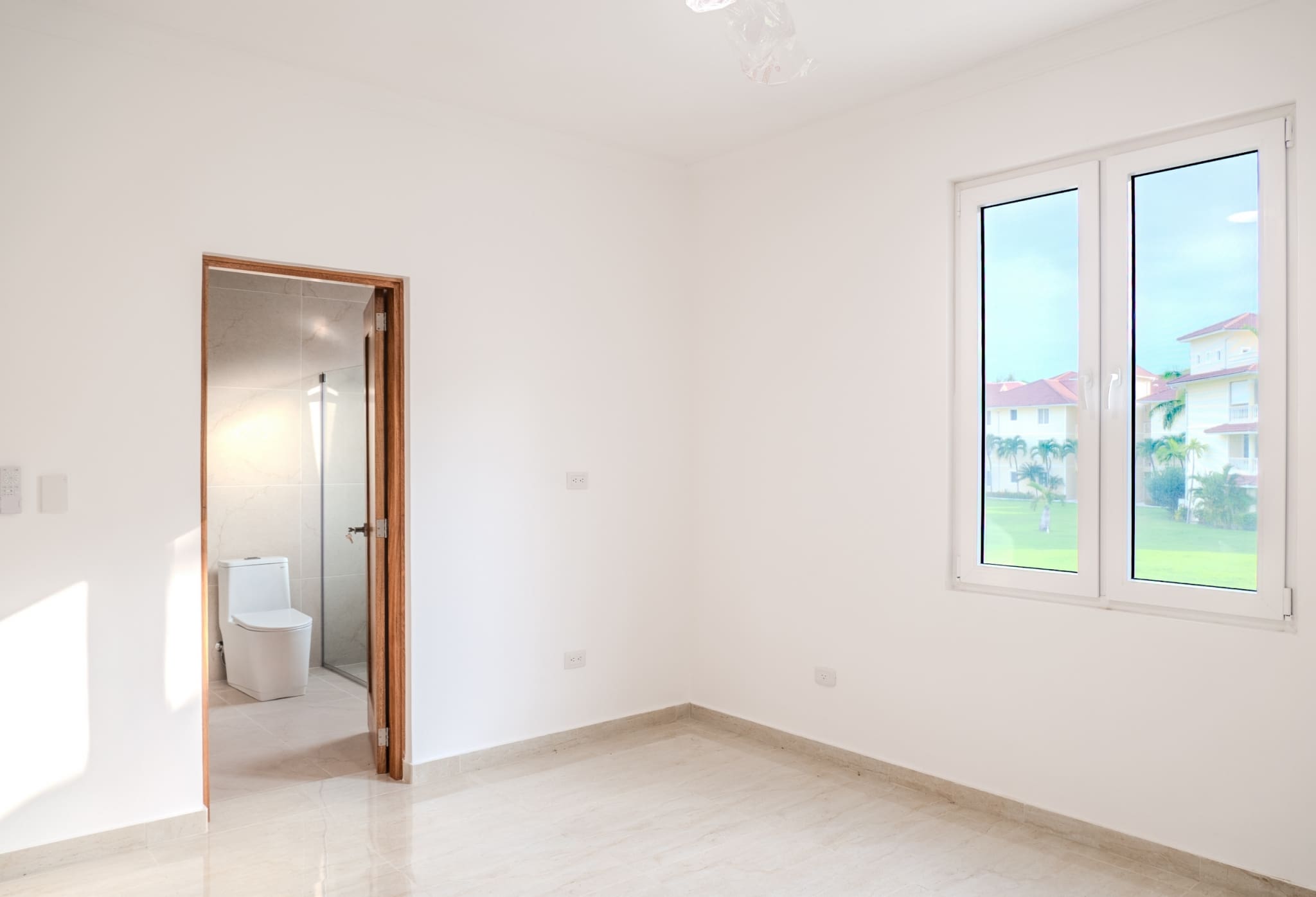 Bright bedroom with ensuite bathroom in Hispaniola Beach condo in Sosua